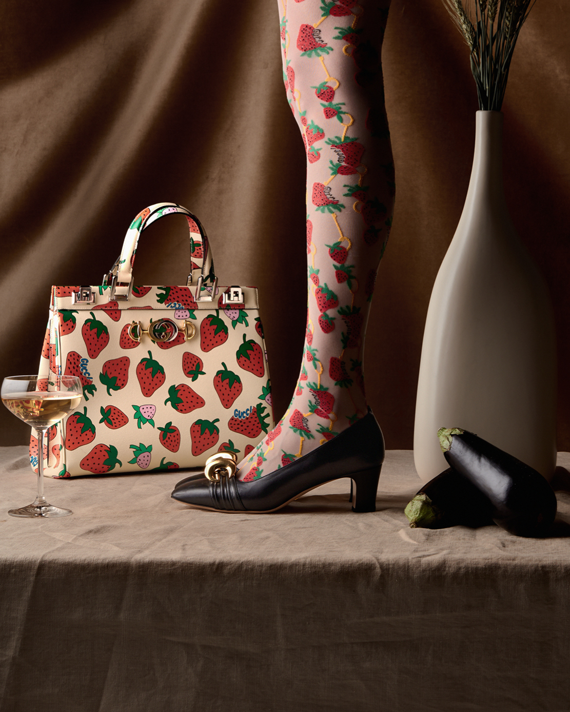 Zumi strawberry print top handled bag, mid-heel pumps with half-moon GG and strawberry print tights