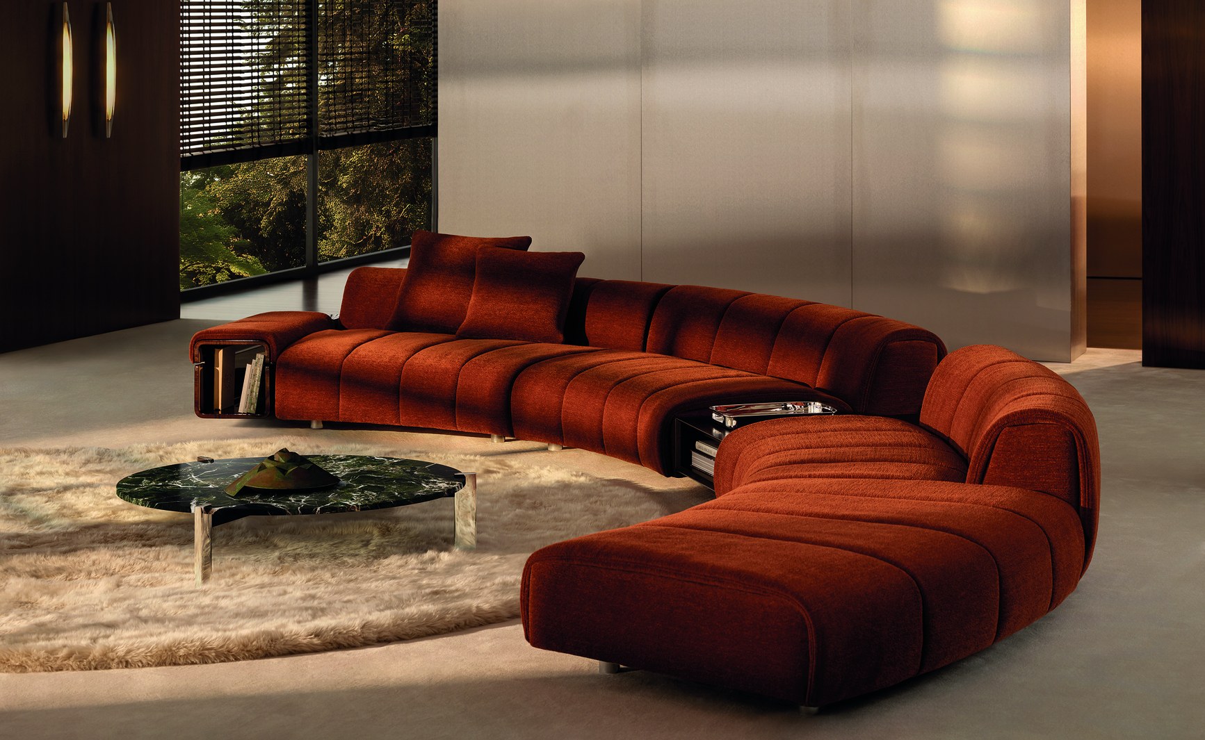 Large curved rust-red chenille sectional sofa with channel tufting in a moody luxury living room.