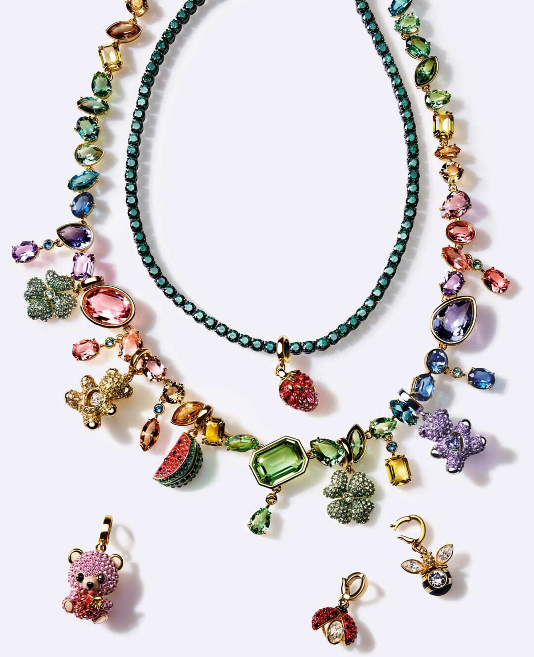 Two Swarovski crystal necklaces with colourful gemstone charms including strawberry, watermelon, and teddy bear motifs.